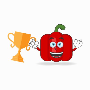 Sağ elinde kupa olan kırmızı biber maskotu karakter..
