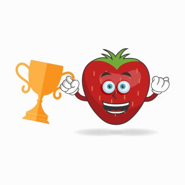 Sağ elinde kupa olan çilek maskotu karakter..