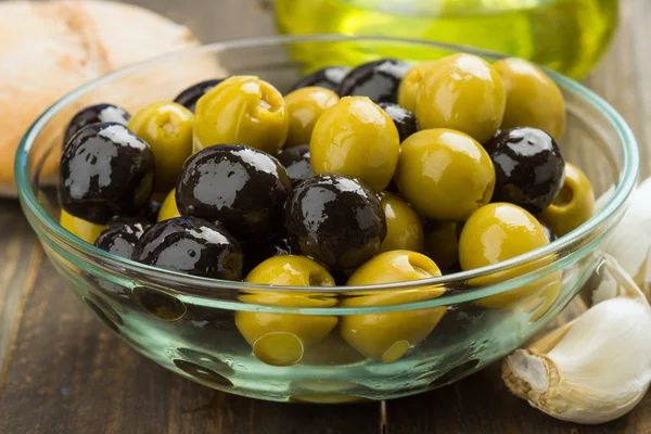 olives, black and green in glass bowl
