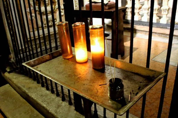 striking image of a group of votive candles in a church