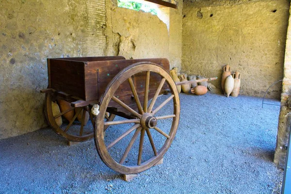 Pompeii, İtalya, 26 Haziran 2020 M.S. 79 'da Vesuvius volkanı patlamasının ardından yapılan kazılardan sonra bulunan antik Roma şehri. Arka planda antik amforalar olan bir savaş arabasının yeniden inşası