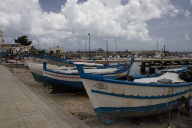 İtalya 'nın Sicilya kentindeki küçük bir balıkçı köyünde demirlemiş balıkçı teknelerinin canlandırıcı görüntüsü.