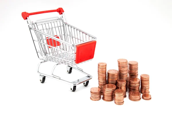 Shopping cart and pile of coins — Stock Photo, Image