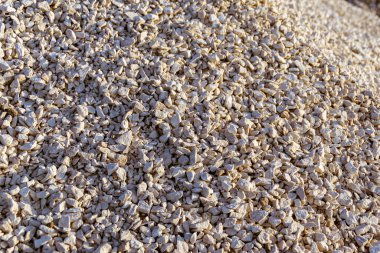 pile of dolomite rubble stockpiled for use in construction, selective focus clipart
