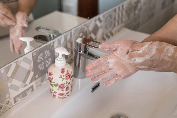 woman washes her hands with soap, disinfects her hands from viruses