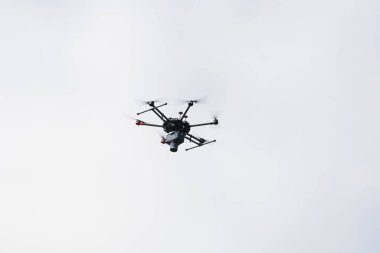Bulutlarla, teknoloji ekipmanlarıyla gökyüzünde uçan dron