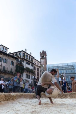 VERONA, ITALY, NOVEMBER, 14, 2019: (Tocat - Uluslararası Sokak Oyunları Festivali), Geleneksel Brittany Oyunları, Breton güreşi, kum ringinde dövüşen iki adam, Lutte Bretonne