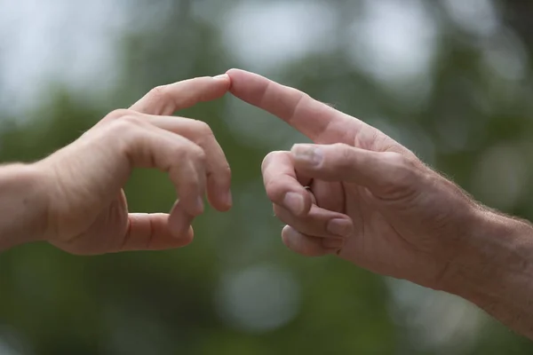 two hands touching their fingers, concept the Global Gender Gap