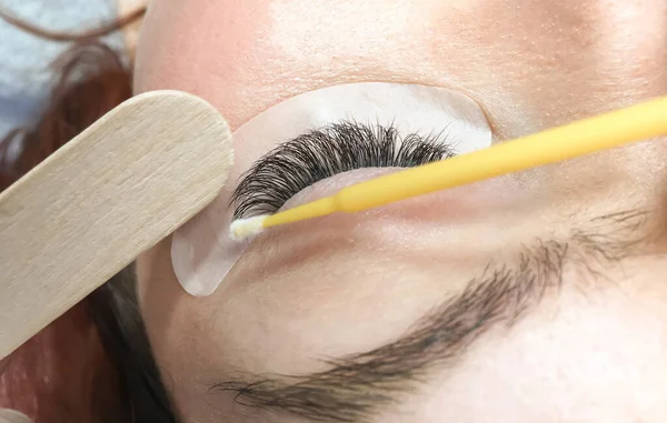 Primer plano del procedimiento de eliminación de la extensión de la pestaña. Retrato de una mujer en un salón de belleza — Foto de Stock