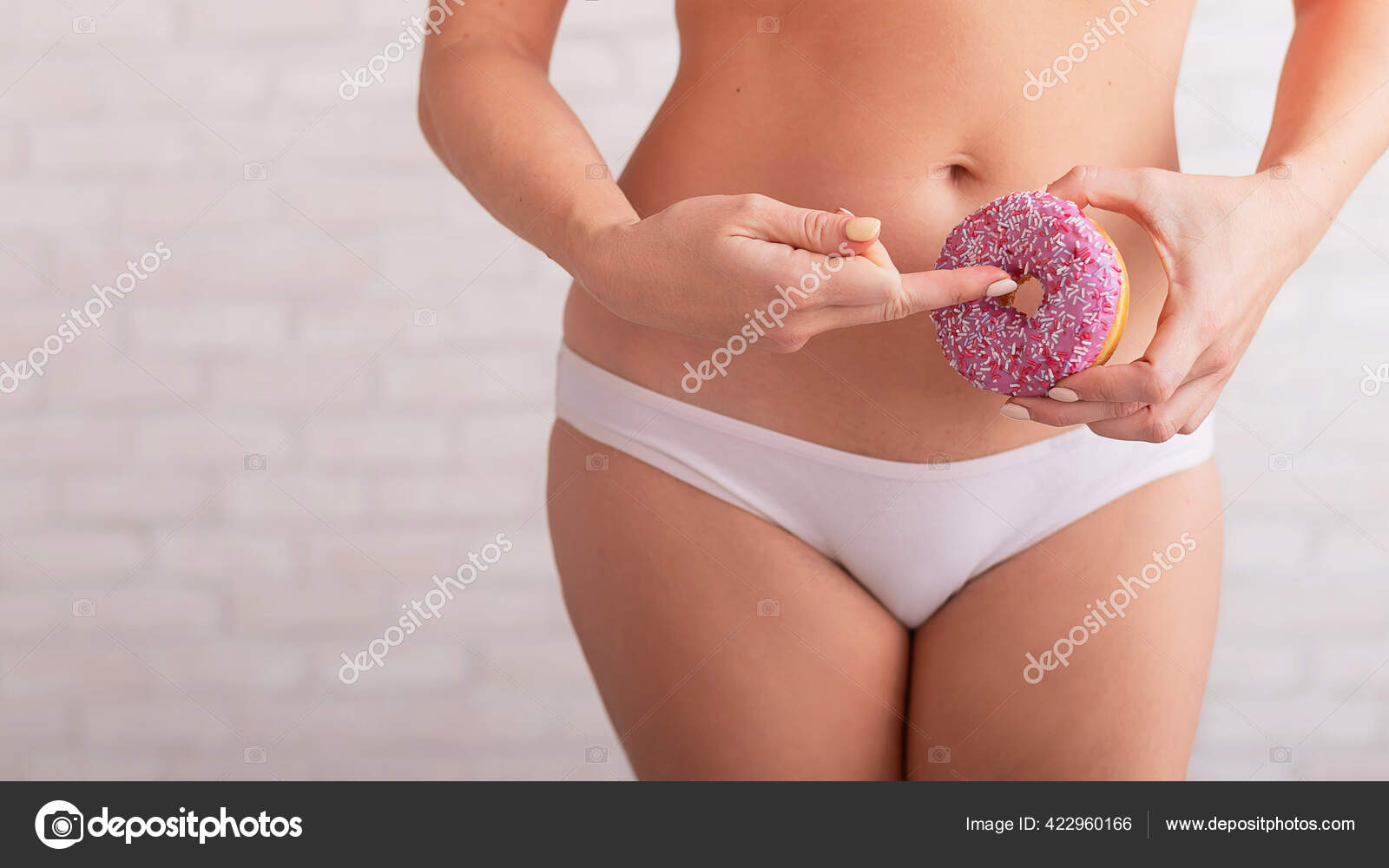 A faceless woman in white panties holds a pink donut imitating