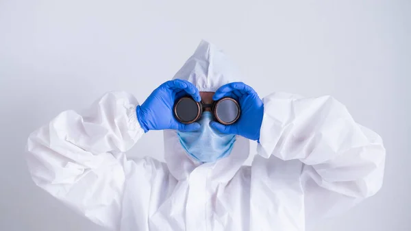 Mujer doctora en traje de protección se aferra a las gafas — Foto de Stock