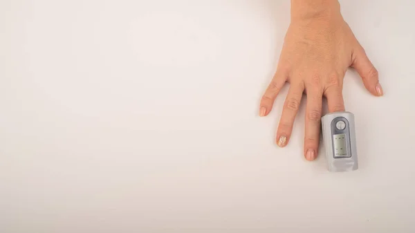 Female hand with a measuring device saturation. Blood oxygen level in coronavirus — Stock Photo, Image