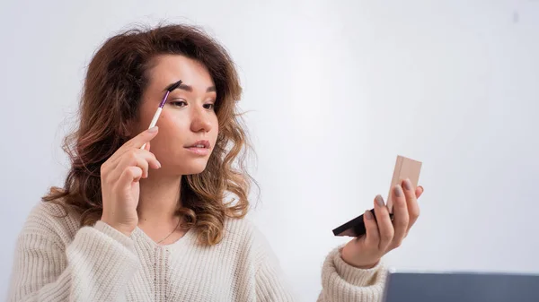 Online training for make-up. A woman teacher explains the makeup application scheme on the air