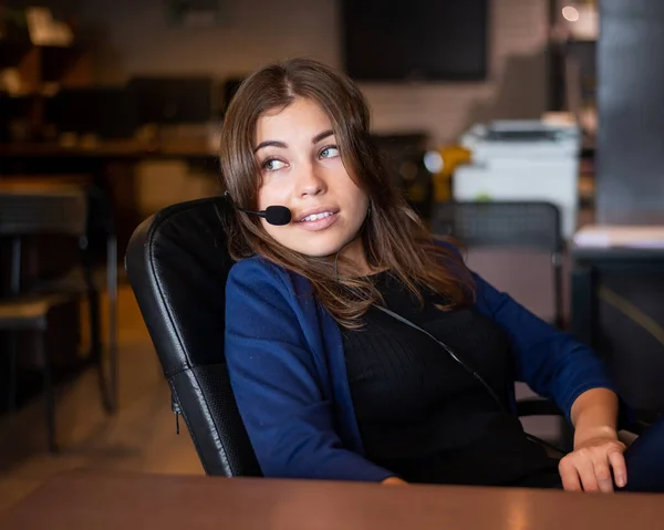 Beautiful caucasian woman call center operator at work desk.