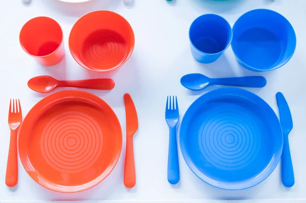 Top view of a plastic crockery set on a white background