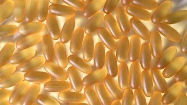 Altın omega üç kapsülüne yakın çekim. Beslenme takviyesi balık yağı beyaz arka planda döner