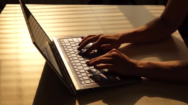 La femme tape sur un ordinateur portable. Gros plan des mains féminines sur le clavier.