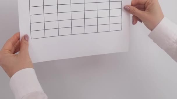 Cropped view of woman attaching 30 days challenge calendar to the wall — Stock Video