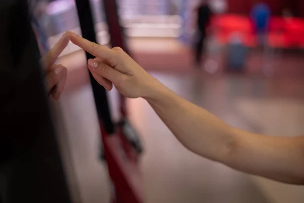 Primer plano de la mano femenina en el mostrador de información de pantalla táctil en el centro comercial. —  Fotos de Stock