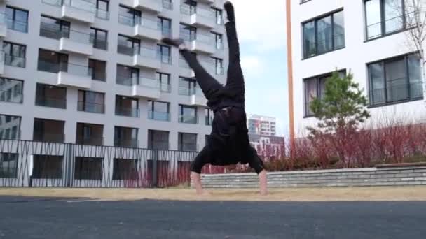 Joven caucásico hombre haciendo somersault al aire libre. — Vídeos de Stock