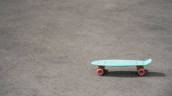 Blue penny board on the pavement. Copy space — Zdjęcie stockowe