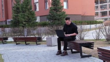Dizüstü bilgisayarda yazan adam sinirleniyor ve dışarıda kırıyor. Yavaş çekim