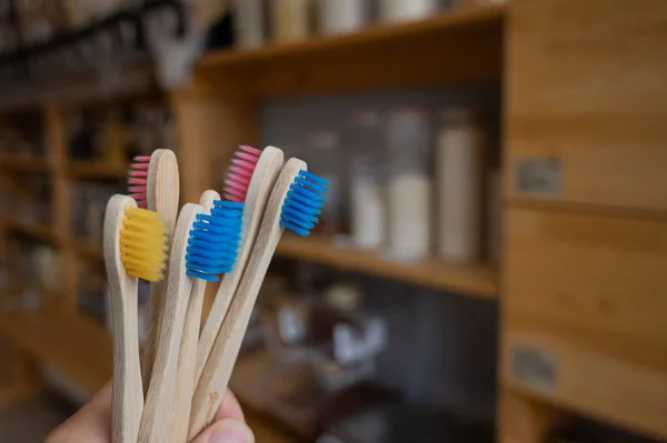 A woman is holding several eco-friendly bamboo toothbrushes — Stock Photo, Image