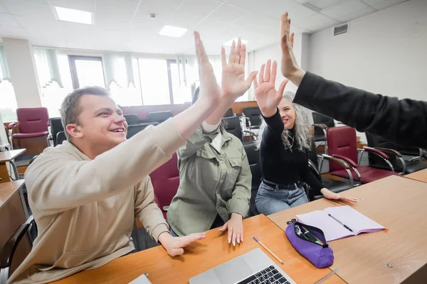 Studenten und Dozent geben im Hörsaal der Universität eine hohe Fünf. — Stockfoto