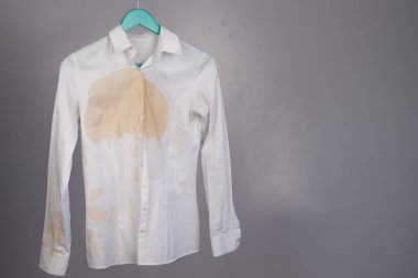 Beyaz arka planda kahve lekesi olan kadın ofis beyaz gömleği..