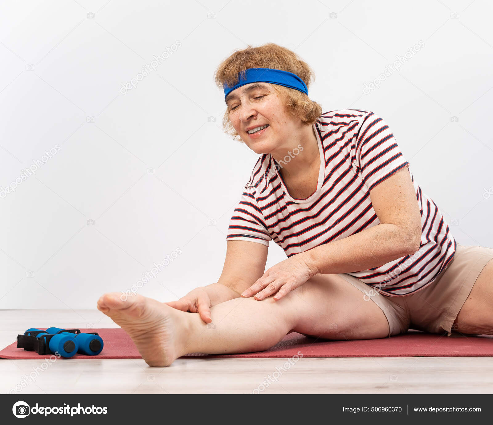 Elderly woman doing squats on a white background. The old lady is