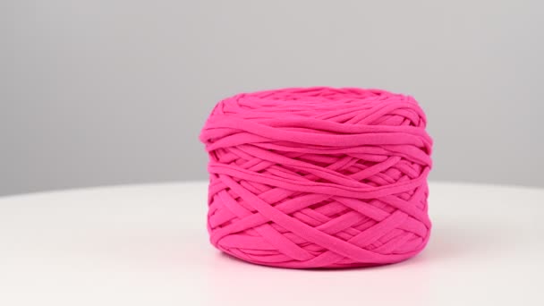 Skein of fuchsia cotton yarn spinning on white background. — Stock Video