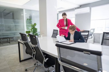 Beyaz kadın astlarına talimat veriyor.