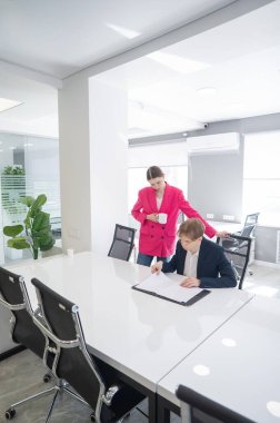 Beyaz kadın astlarına talimat veriyor.