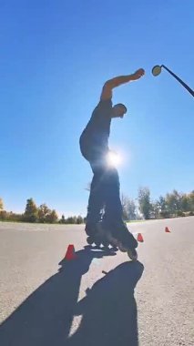 Beyaz bir adam slalom pistinde paten kayıyor.