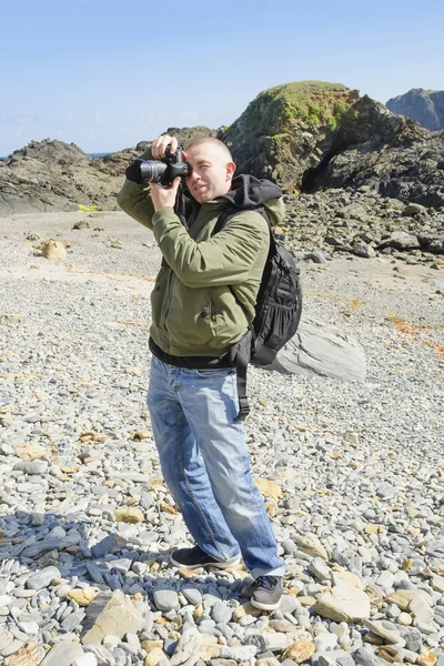 Young Tourist With Backpack Sightseeing and making photos on nature Royalty Free Stock Photos