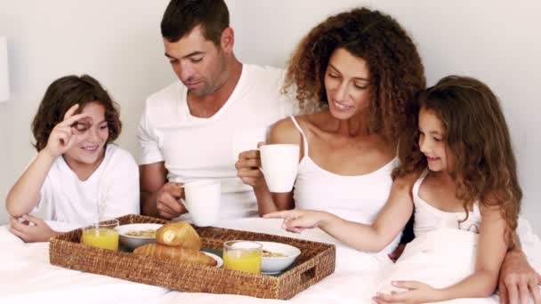 Cute family having breakfast in bed — Stock Video