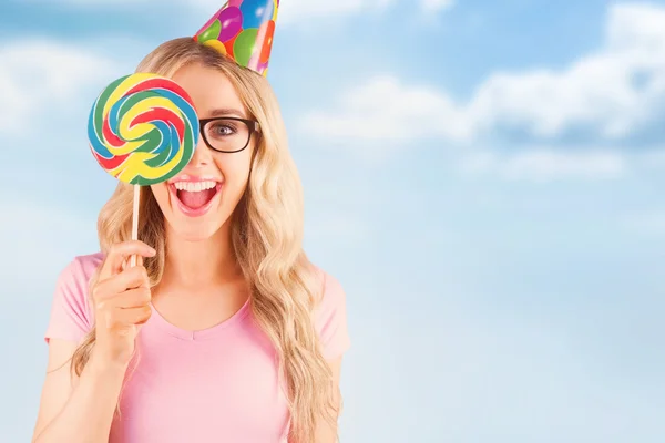 Hipster hiding behind a  lollipop — Stock Photo, Image