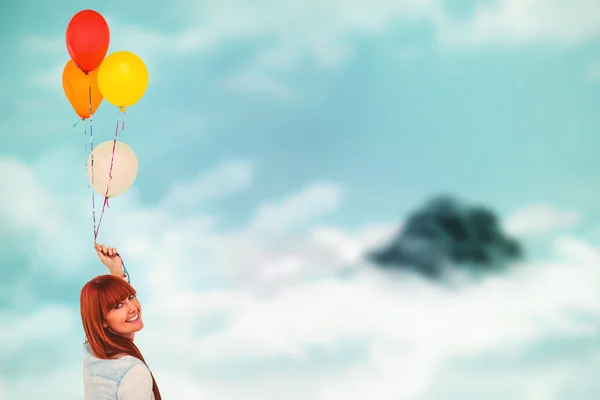 Smiling hipster  holding balloons — Stock Photo, Image