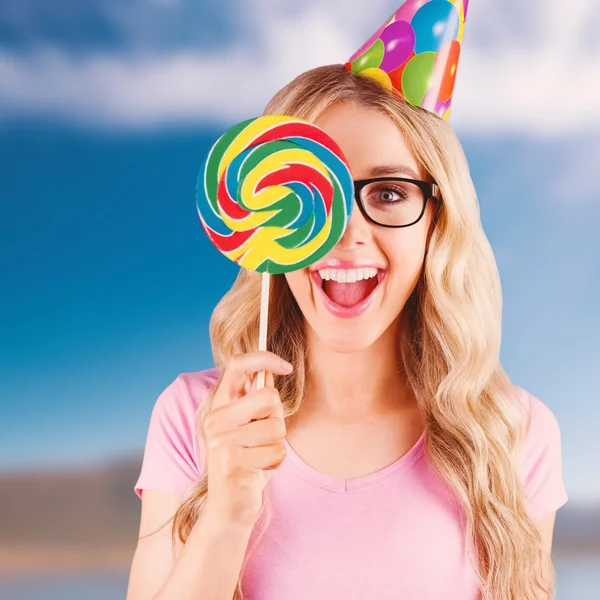 Hipster hiding herself behind a lollipop — Stock Photo, Image