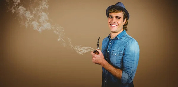 Cheerful hipster holding pipe — Stock Photo, Image