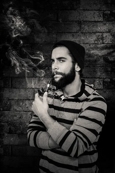 Serious hipster smoking pipe — Stock Photo, Image