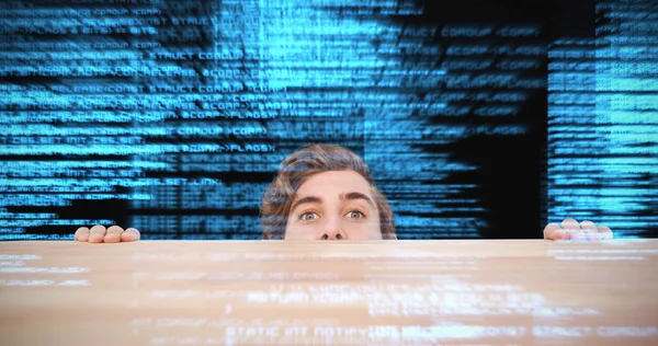 Man hiding behind desk — Stock Photo, Image