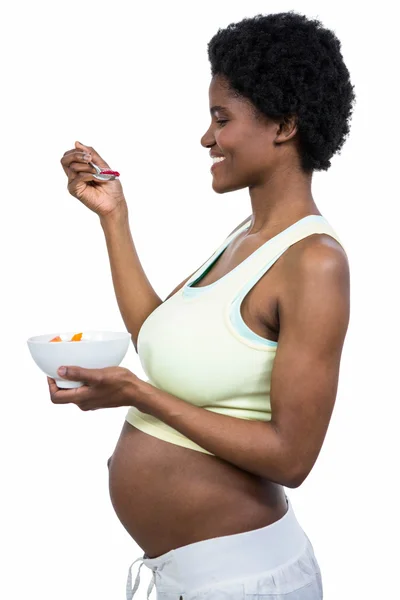 Pregnant woman eating fruit salad — Stock Photo, Image