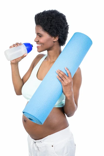 Zwangere vrouw holding waterfles en mat — Stockfoto