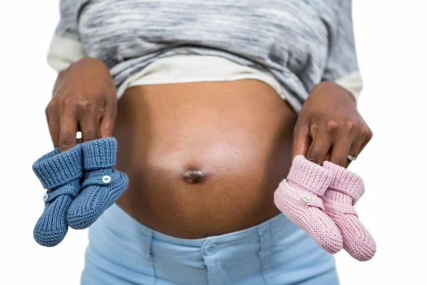 Pregnant woman holding baby shoe — Stock Photo, Image