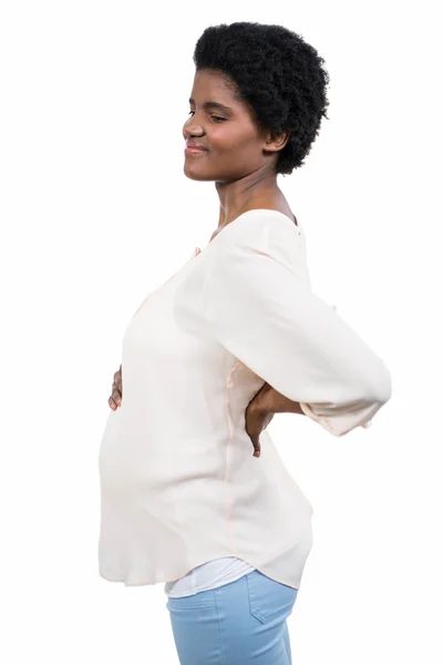 Беременная женщина с болью в спине — стоковое фото