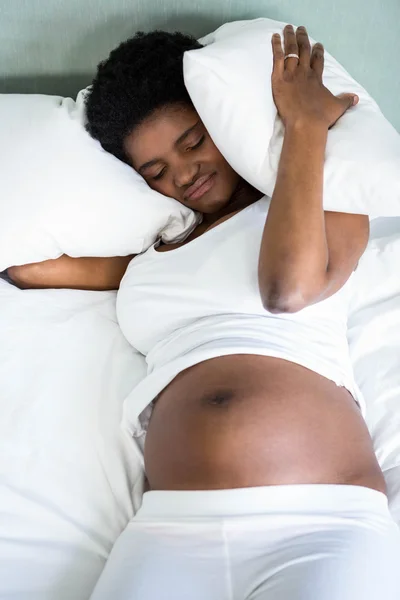 Pregnant woman covering her ears — Stock Photo, Image