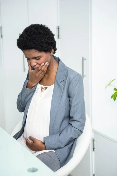 Pregnant businesswoman feeling sick — Stock Photo, Image