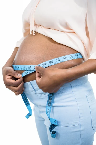 Pregnant woman measuring her belly Stock Picture