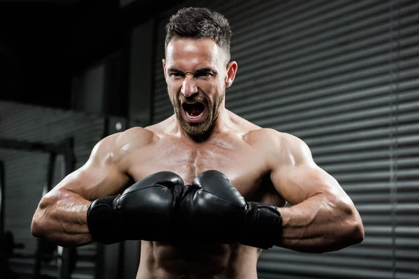 Irritado homem sem camisa com luvas boxe gritando — Fotografia de Stock